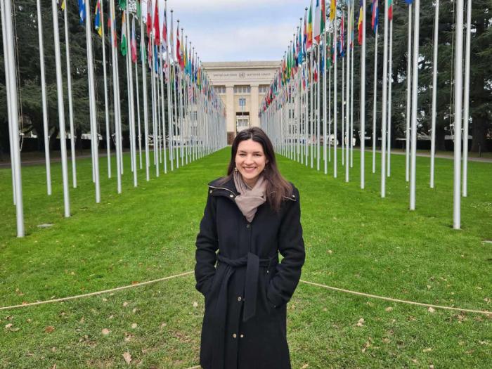 Hatch poses in front of the Palais des Nations and the walkway of flags