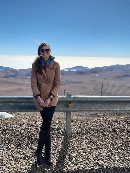 Maggie poses with mountains in the distance