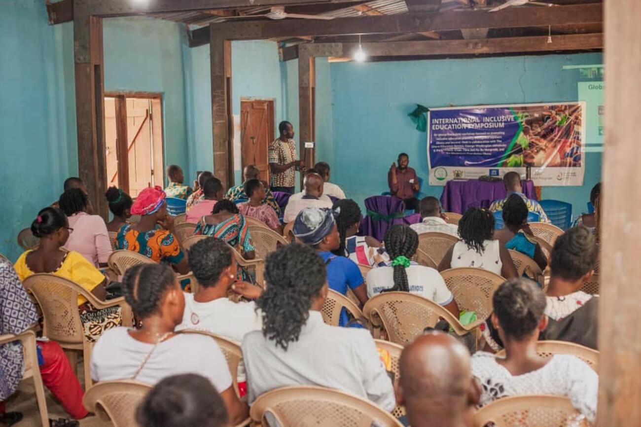 photo taken from behind seated attendees at IIES event, speaker stands at the front of the room