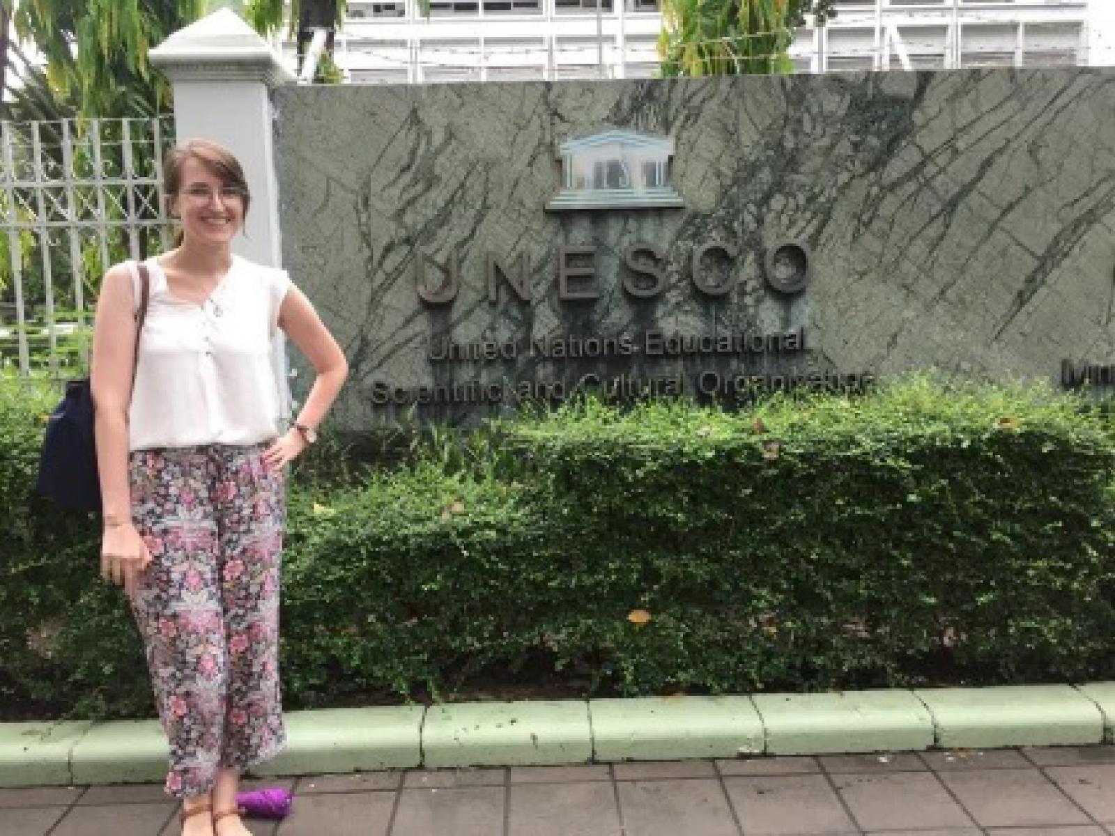 Brynn poses in front of the UNESO sign