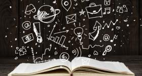 open book with illustrations of academic related items rising from it