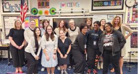 Principal Jamie Borg (far left) and Dr. Mary DeRaedt (far right) with GSEHD Elementary Ed Students