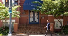 student walks toward GSEHD building