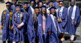 The first cohort of the GSEHD Educational Leadership and Administration program posed for photos their graduation attire in front of Gelman Library.
